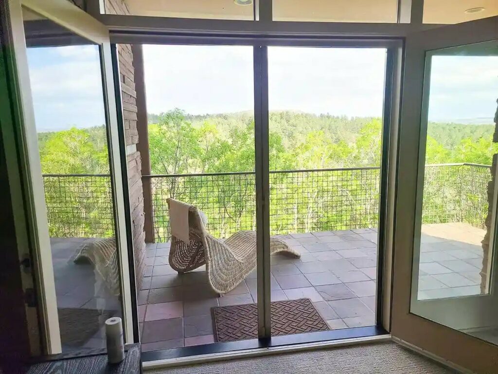 product mirage screens retractable screen doors a room with glass doors and a patio with a view of the water